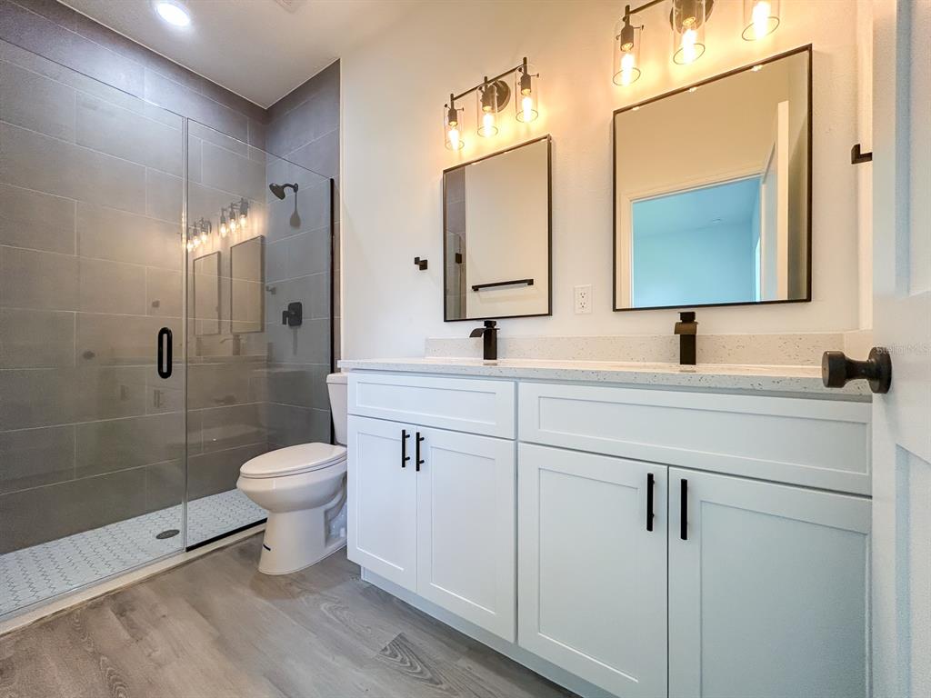 3159 Southwest 127th Lane Road Ocala, FL 34473 - Photo 16 of 32 a bathroom with a toilet sink a shower and mirror