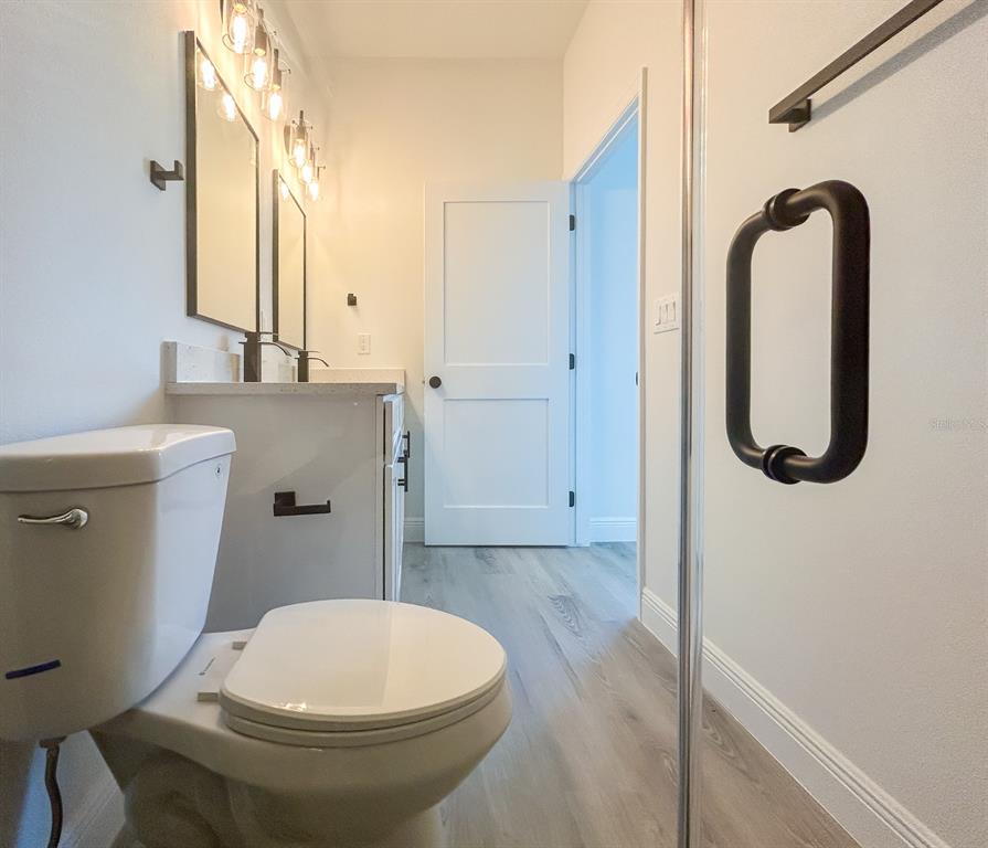3159 Southwest 127th Lane Road Ocala, FL 34473 - Photo 17 of 32 a bathroom with a sink a toilet and a mirror