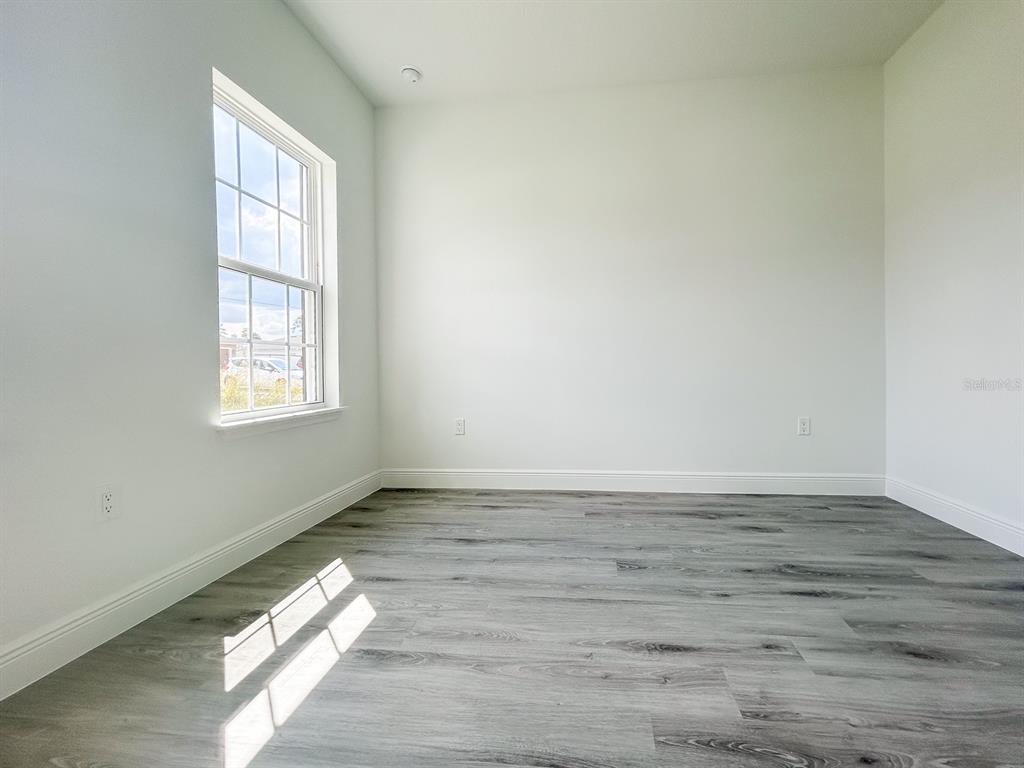 3159 Southwest 127th Lane Road Ocala, FL 34473 - Photo 19 of 32 a view of an empty room with wooden floor and a window