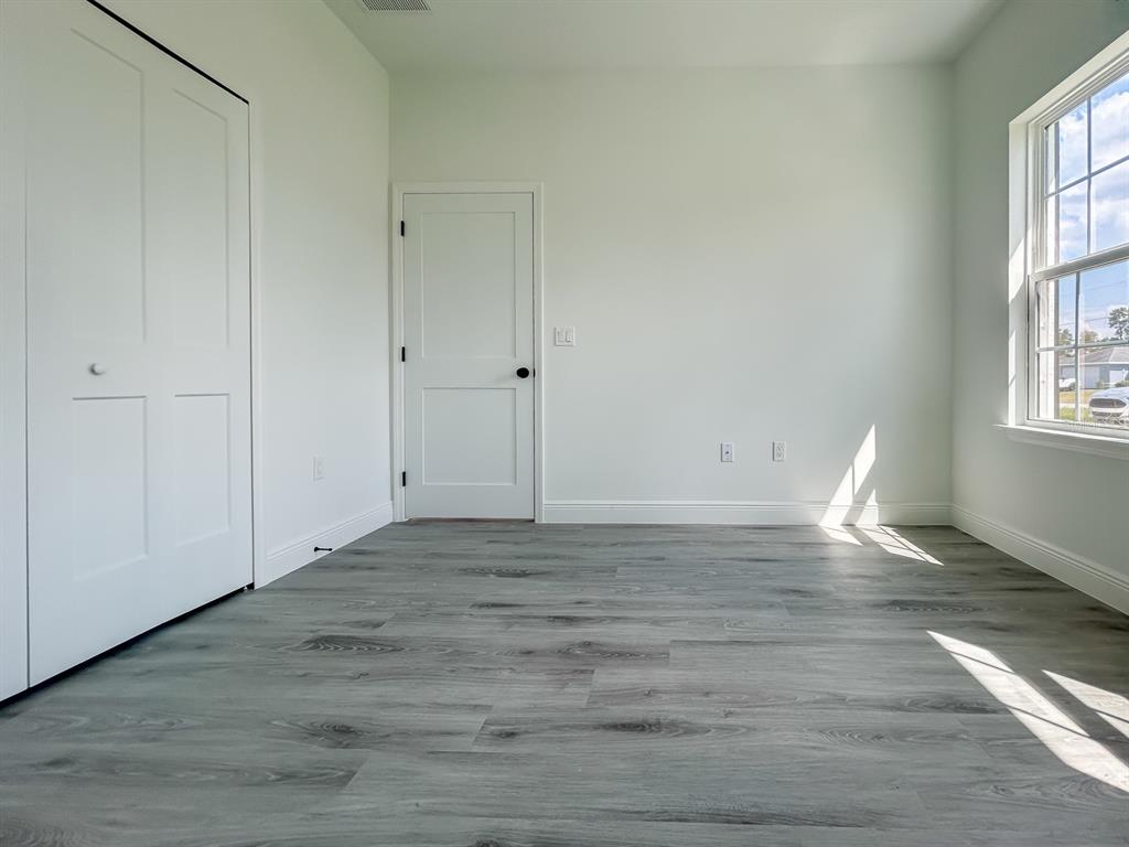 3159 Southwest 127th Lane Road Ocala, FL 34473 - Photo 20 of 32 a view of empty room with wooden floor and fan