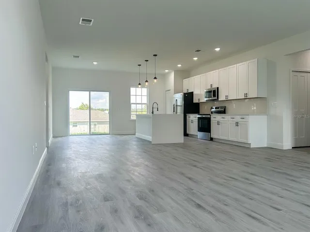 a view of a kitchen with a sink and a stove