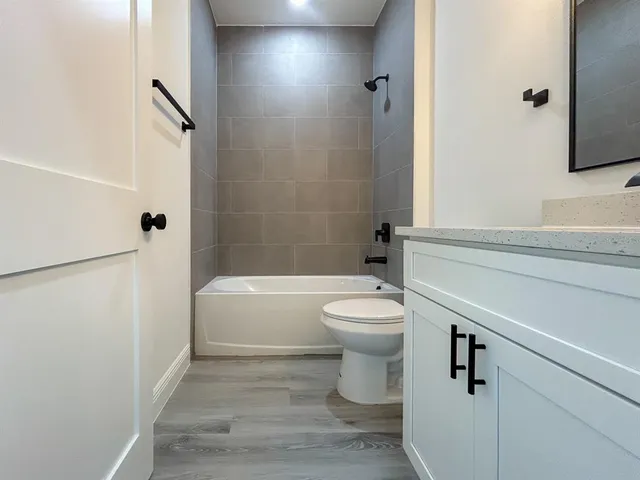 a bathroom with a toilet a sink a vanity and mirror