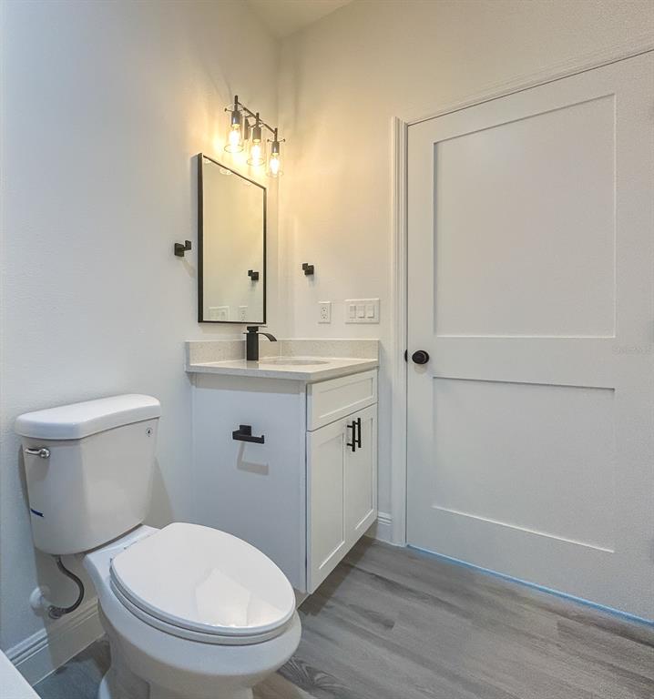 3159 Southwest 127th Lane Road Ocala, FL 34473 - Photo 28 of 32 a bathroom with a toilet a sink a vanity and mirror