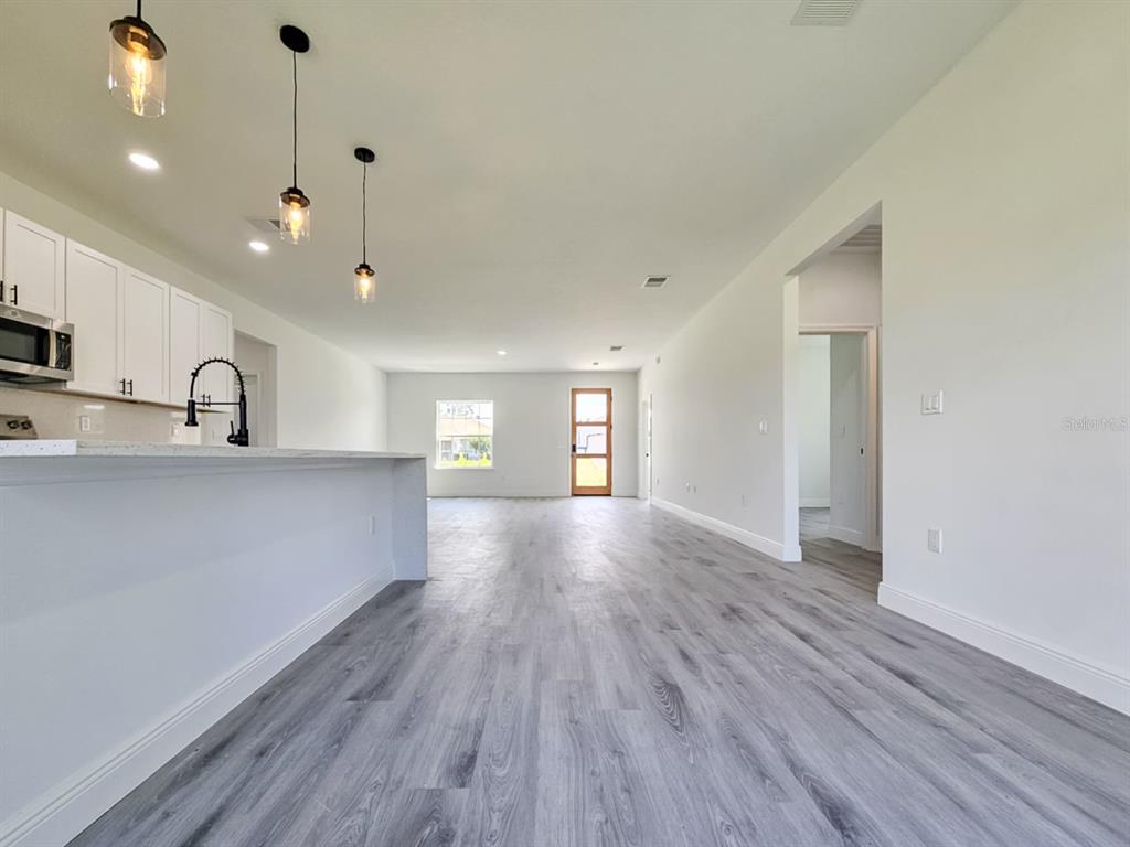 3159 Southwest 127th Lane Road Ocala, FL 34473 - Photo 9 of 32 a view of a kitchen with wooden floor and a sink