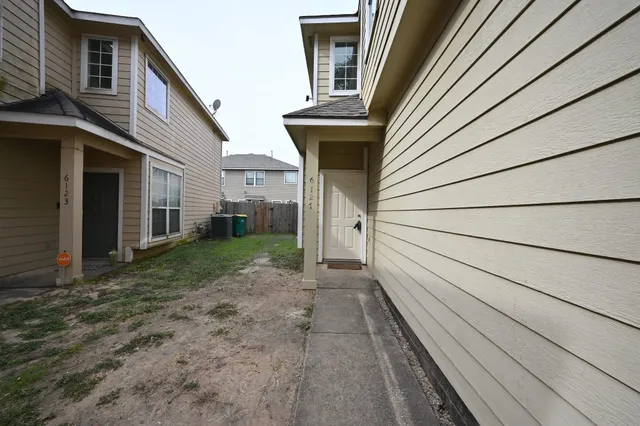 a view of a house with a backyard