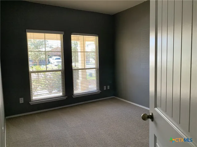 a view of empty room with windows