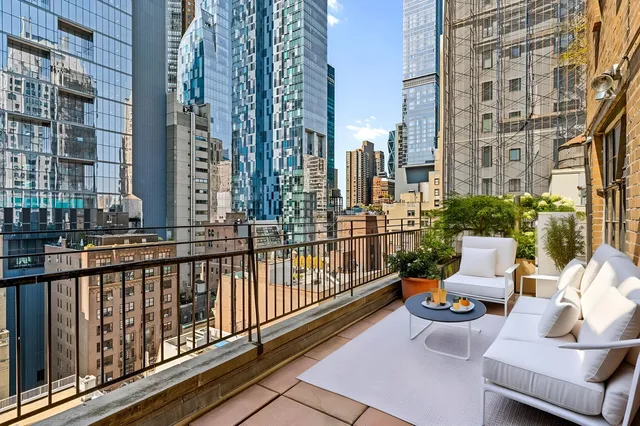 a view of a balcony with outdoor seating