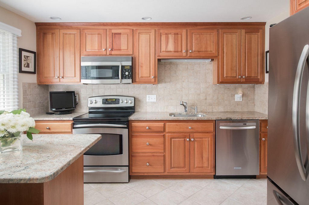 21 Spruce Road Medway, MA 02053 - Photo 12 of 26 a kitchen with stainless steel appliances granite countertop a refrigerator stove and sink