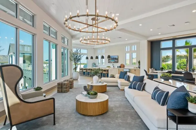 a living room with furniture chandelier and a large window