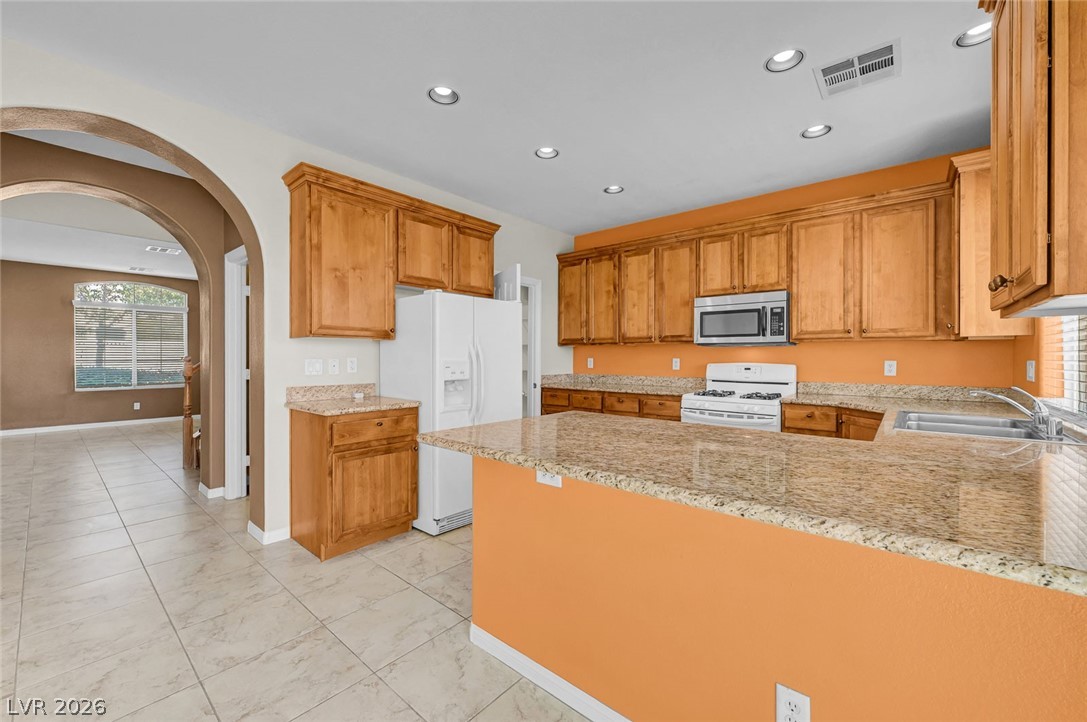 977 Sparkling Light Street Henderson, NV 89052 - Photo 29 of 75 This spacious kitchen offers ample cabinet space and modern appliances, perfect for everyday living.