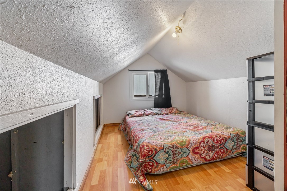 1915 Gibson Road, Unit A Everett, WA 98204 - Photo 22 of 23 a bedroom with a large bed and a chandelier