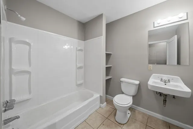 a bathroom with a toilet a sink and bathtub