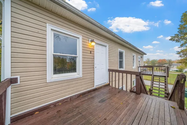 a view of a balcony with wooden floor