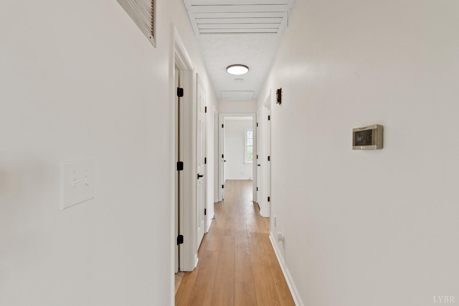 9108 Wheelers Spring Road Appomattox, VA 24522 - Photo 12 of 50 a view of a hallway with wooden floor and a mirror