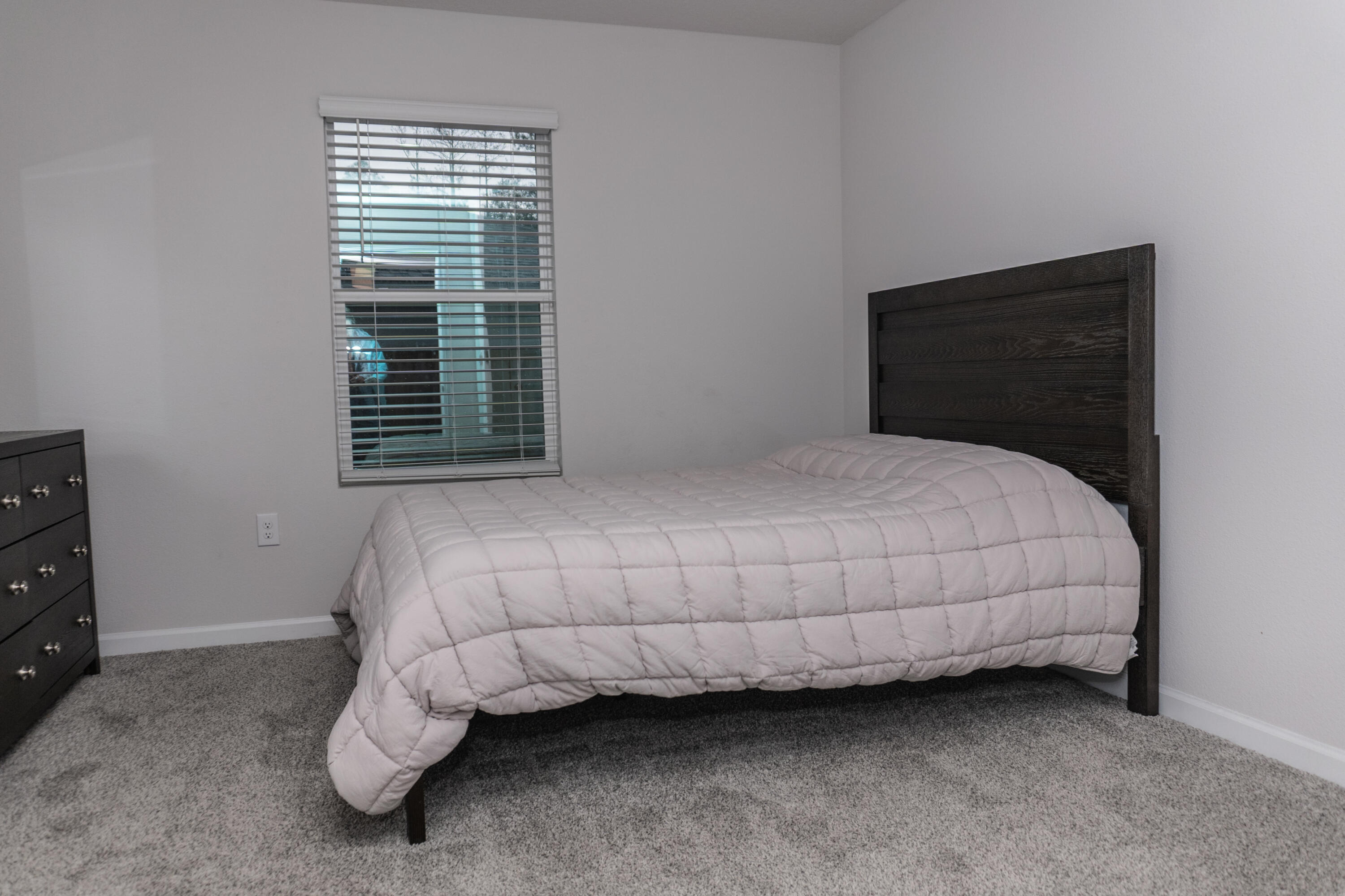 3431 Phoenix Court Crestview, FL 32539 - Photo 24 of 29 a bed sitting in a bedroom next to a window