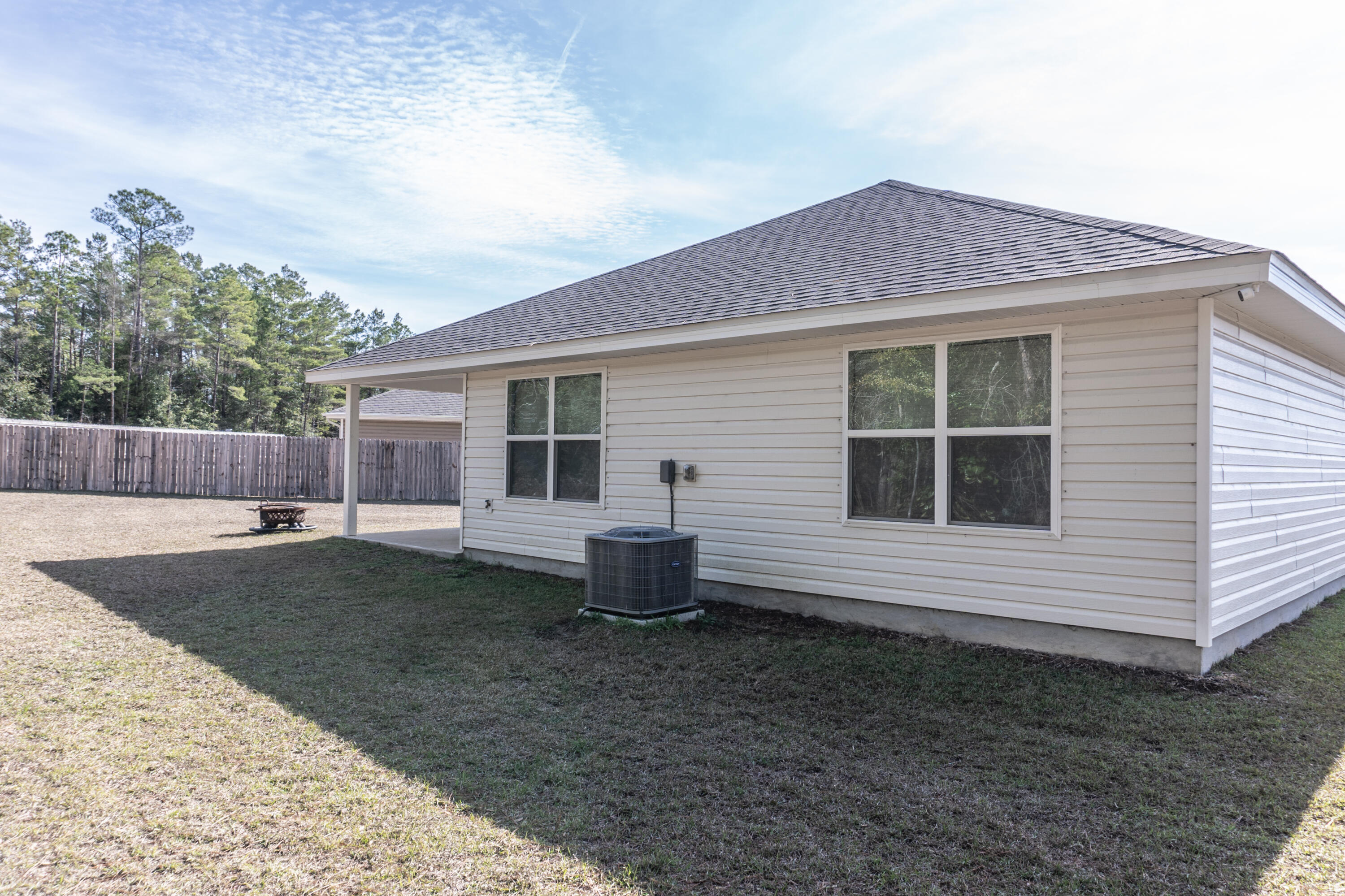 3431 Phoenix Court Crestview, FL 32539 - Photo 29 of 29 a view of a house with a yard and wooden fence
