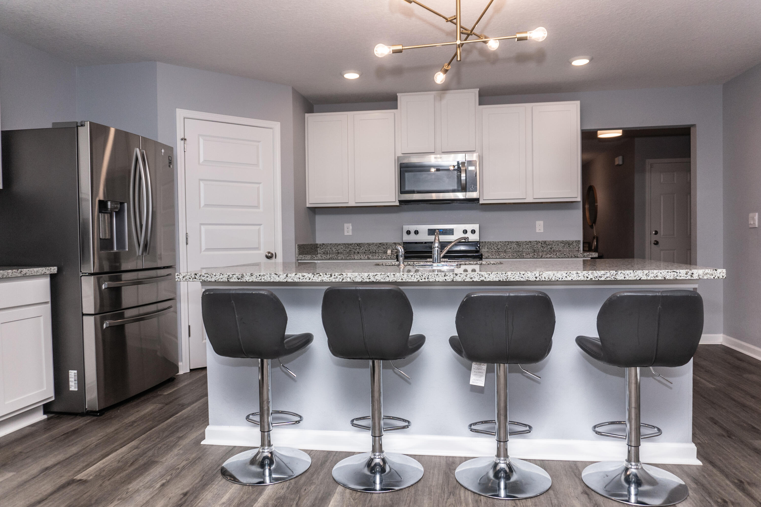 3431 Phoenix Court Crestview, FL 32539 - Photo 7 of 29 a kitchen with stainless steel appliances granite countertop a sink refrigerator and cabinets