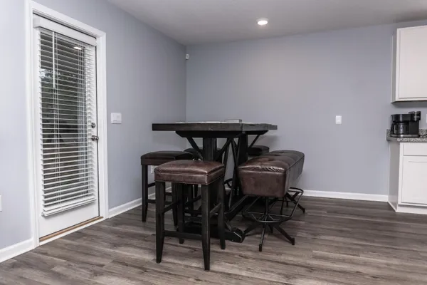 a view of a workspace with furniture and wooden floor