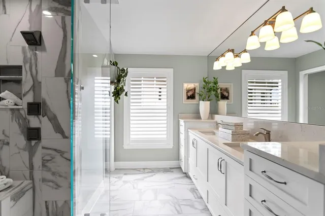 a spacious bathroom with a double vanity sink a mirror and a shower