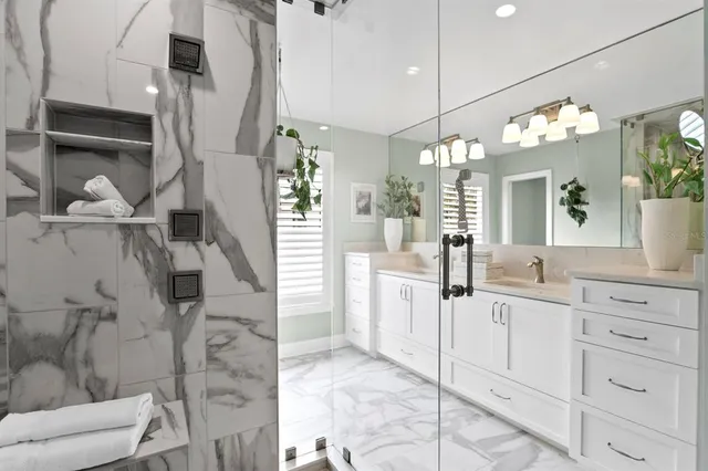 a bathroom with a sink vanity and mirror