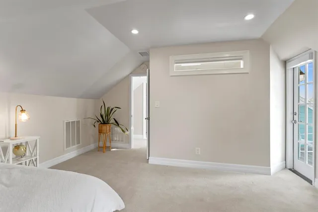 a bedroom with a bed and a large mirror