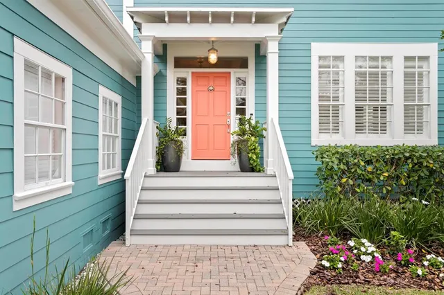 a view of a house with potted plants