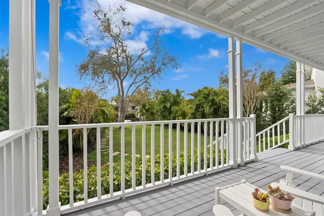 a view of a balcony with wooden floor and fence
