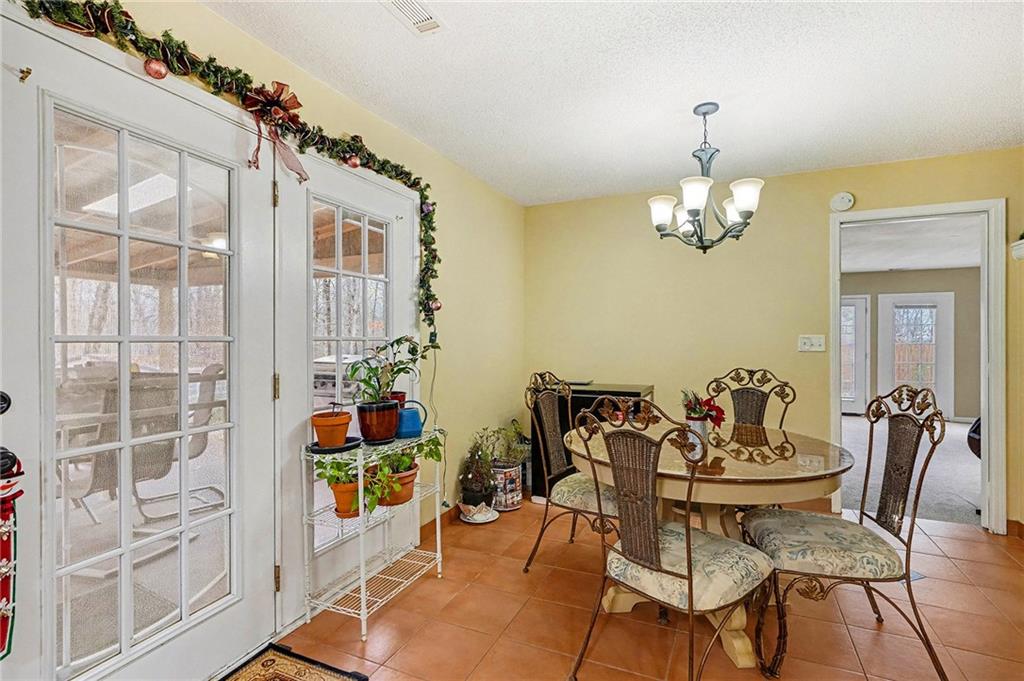 235 Cecil Jackson Road Griffin, GA 30223 - Photo 12 of 34 a view of a dining room with furniture and chandelier