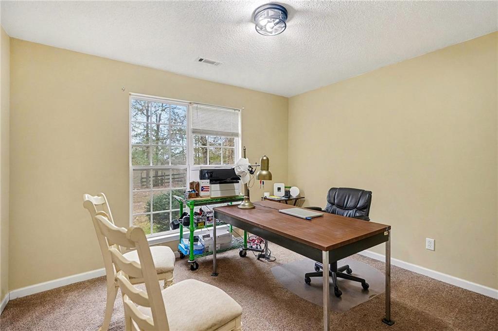 235 Cecil Jackson Road Griffin, GA 30223 - Photo 19 of 34 a view of a workspace with a window