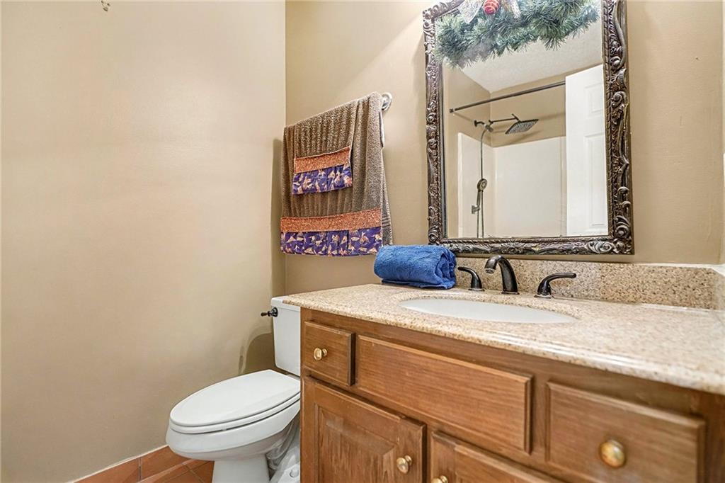 235 Cecil Jackson Road Griffin, GA 30223 - Photo 20 of 34 a bathroom with a toilet sink and mirror