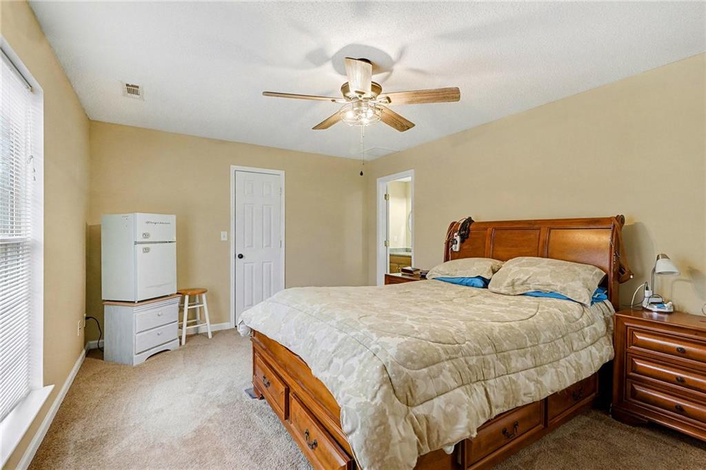 235 Cecil Jackson Road Griffin, GA 30223 - Photo 22 of 34 a bedroom with a bed and a chandelier