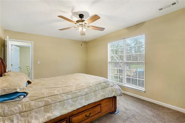 a bedroom with a large bed and a window