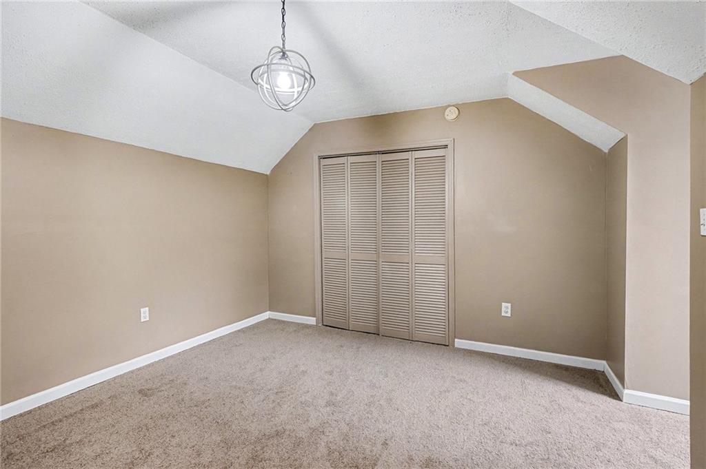 235 Cecil Jackson Road Griffin, GA 30223 - Photo 28 of 34 a view of an empty room with a chandelier fan
