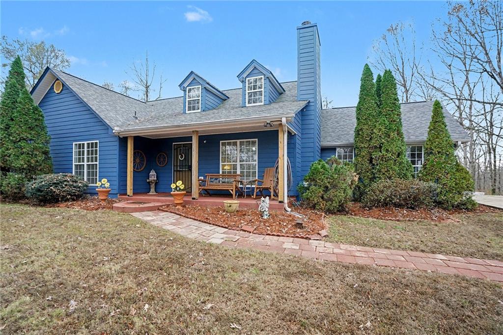 235 Cecil Jackson Road Griffin, GA 30223 - Photo 33 of 34 a view of a brick house with large windows and a table and chairs