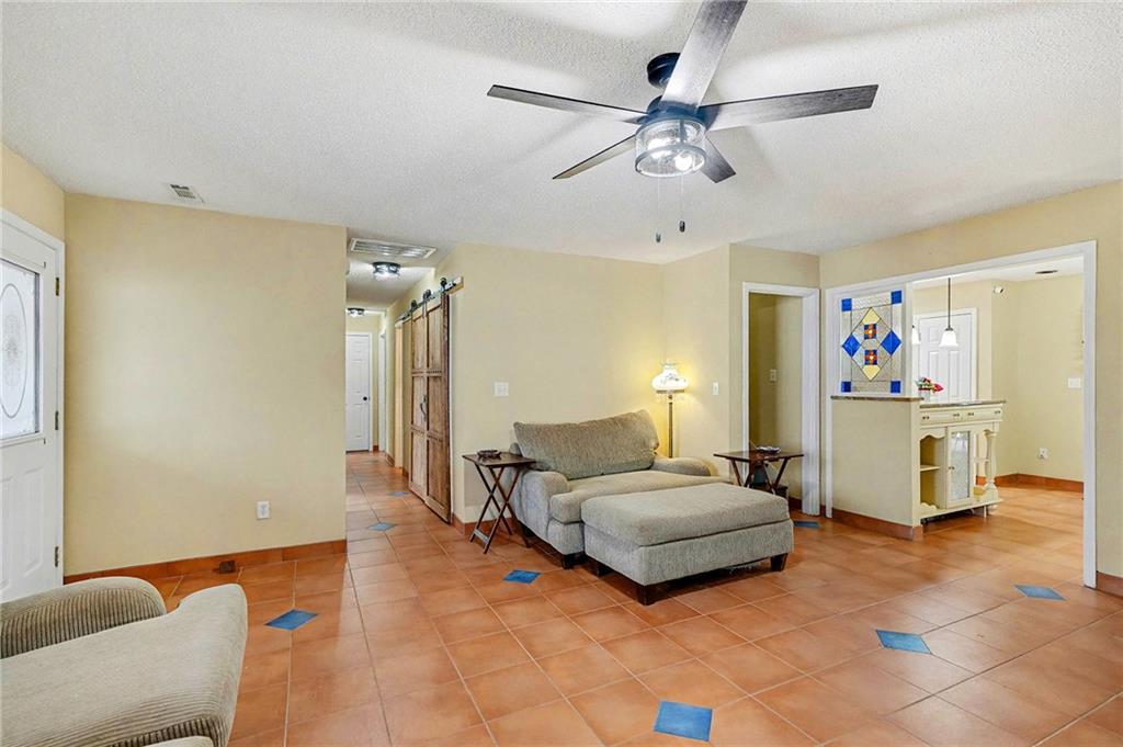 235 Cecil Jackson Road Griffin, GA 30223 - Photo 6 of 34 a bedroom with a bed and a chandelier