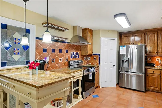 a kitchen with stainless steel appliances granite countertop a sink refrigerator and microwave