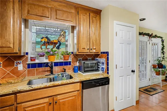 a kitchen with stainless steel appliances granite countertop a refrigerator and a stove