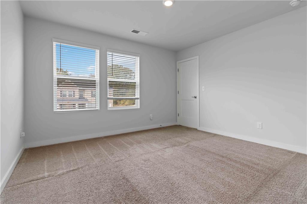 163 Kingfisher Walk Covington, GA 30014 - Photo 20 of 41 a view of an empty room with a window