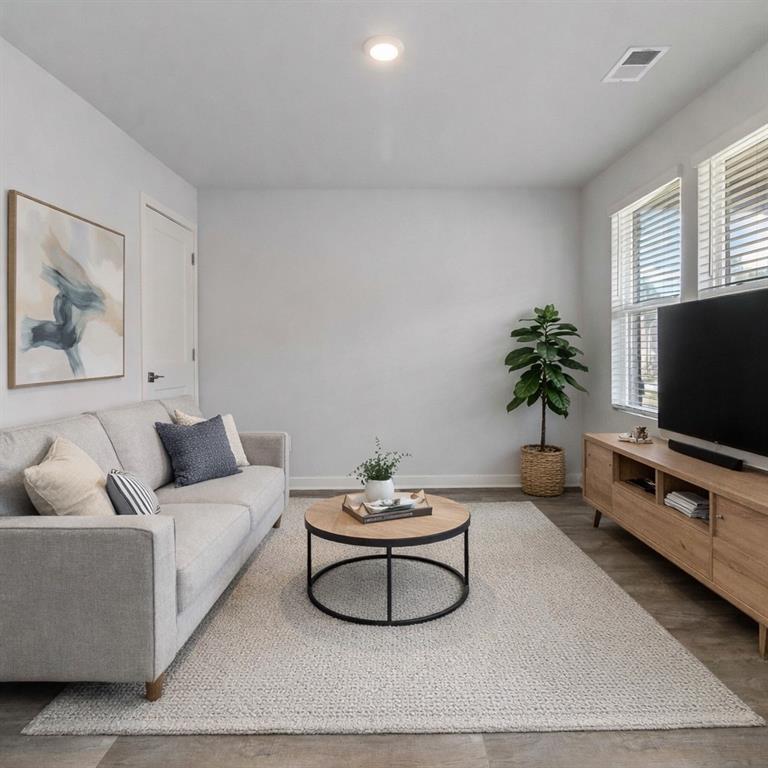 163 Kingfisher Walk Covington, GA 30014 - Photo 6 of 41 a living room with furniture a flat screen tv and a potted plant