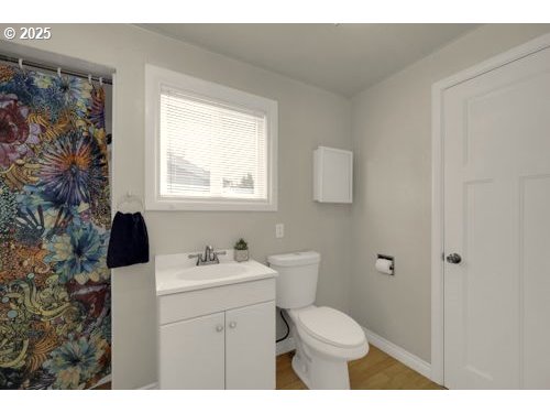 3090 Willakenzie Road Eugene, OR 97401 - Photo 14 of 22 a bathroom with a sink toilet and window