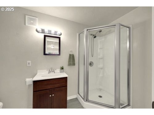 3090 Willakenzie Road Eugene, OR 97401 - Photo 19 of 22 a bathroom with a sink mirror and shower