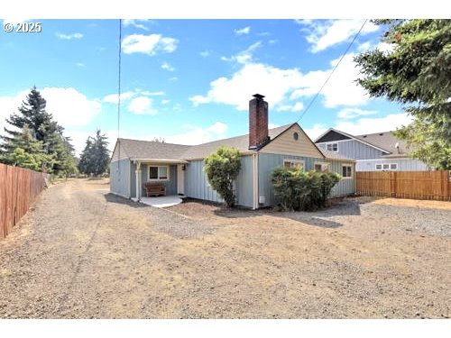 3090 Willakenzie Road Eugene, OR 97401 - Photo 2 of 22 a front view of a house with a yard and garage