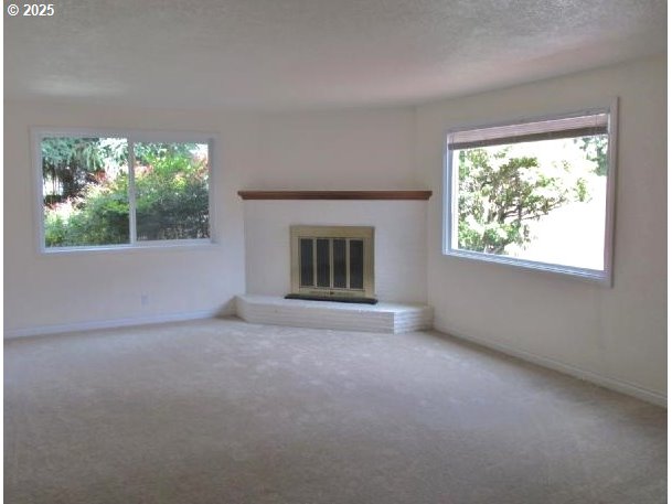 3090 Willakenzie Road Eugene, OR 97401 - Photo 3 of 22 an empty room with windows and an outdoor space