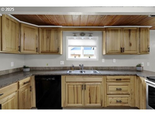 3090 Willakenzie Road Eugene, OR 97401 - Photo 6 of 22 a kitchen with stainless steel appliances granite countertop a sink and cabinets with wooden floor