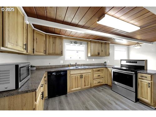 3090 Willakenzie Road Eugene, OR 97401 - Photo 7 of 22 a kitchen with stainless steel appliances granite countertop a stove a sink and a microwave