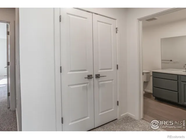 a view of cabinets and utility room with cabinets