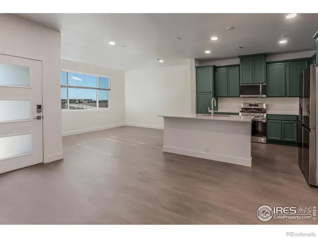 a view of kitchen with cabinets and stainless steel appliances