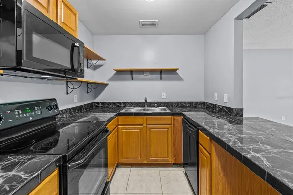 a kitchen that has a sink and a stove