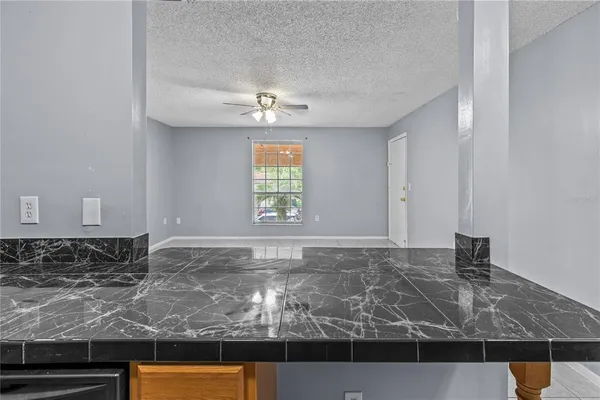 a view of a kitchen with marble kitchen and sink