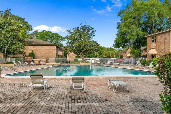 a view of swimming pool with a patio and a yard